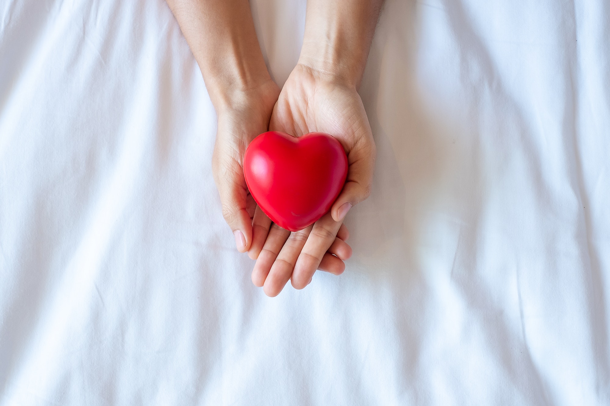 Woman holding Red heart shape, life Insurance, donation, health and World Heart Day concept